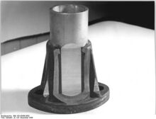 "Eine im Druckspritzverfahren hergestellte Aluminium-Tempergußverbindung.(aufgeschnitten). Sehr deutlich kann man die eingespritzte Gummischicht erkennen. Die Zerreißfestigkeit der Verbindung beträgt über 10 t." (Dezember 1956)