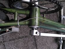 Im lichtgeschützten Tretlagerbereich ist der Originalfarbton noch erhalten. Am übrigen Fahrrad hat sich der lichtempfindliche grüne Metallic-Lack fast gänzlich zu einem graublau-metallic gewandelt.